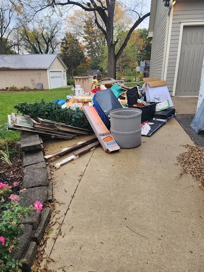 Dumpster being loaded with debris for 12 Yard Dumpster Rental in Plainfield